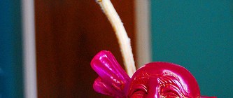 Small Laughing Buddha with flower (image via Buddha Collective)